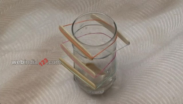 use a rubber band and strap it to a glass