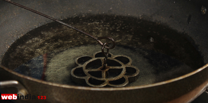 Dip the Achappam mould in the pan