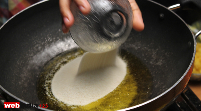 Heat ghee in a pan, add semolina