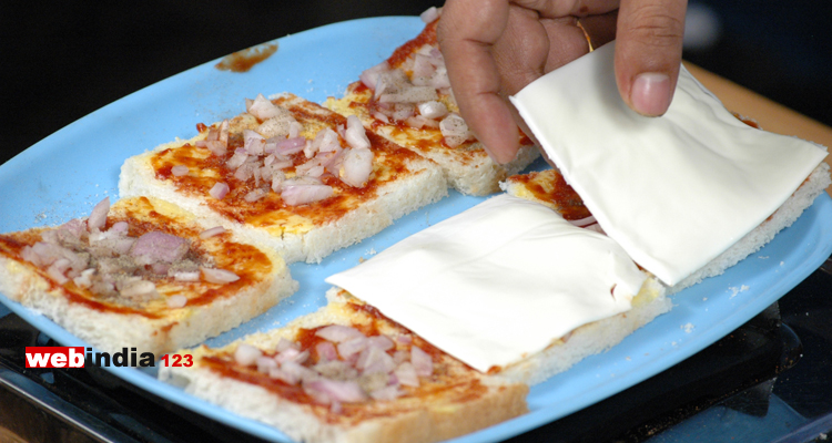 one flat cheese slice on each bread slice