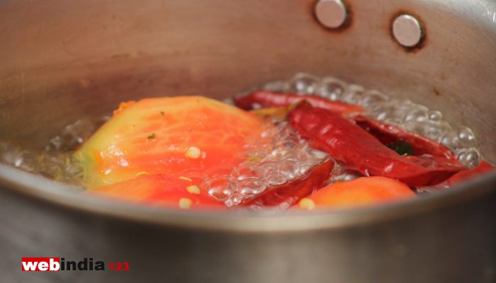 boil tomatoes and red chilies