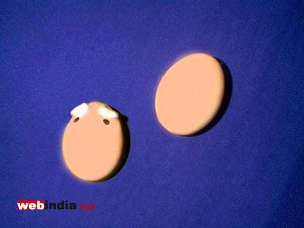 Black dots for eyes and narrow strips of cotton for eyebrows, stuck with glue