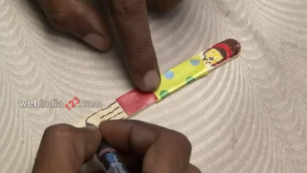 Glue it to the Popsicle sticks