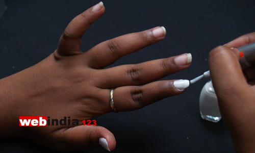 apply a single coat of white nail polish