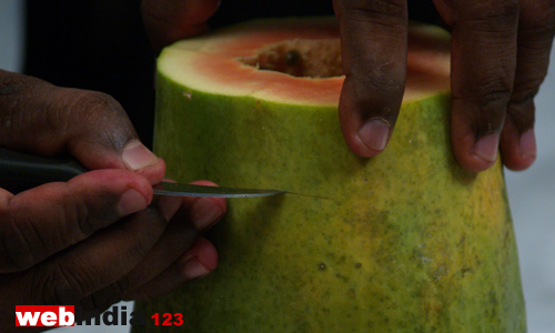 make a line around the papaya with a sharp knife