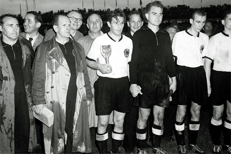 The German team captain Fritz Walter holding the Jules Rimet trophy
